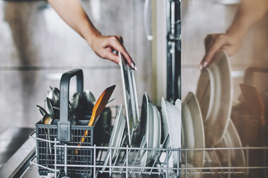 Cleaning dishes in the dishwasher.