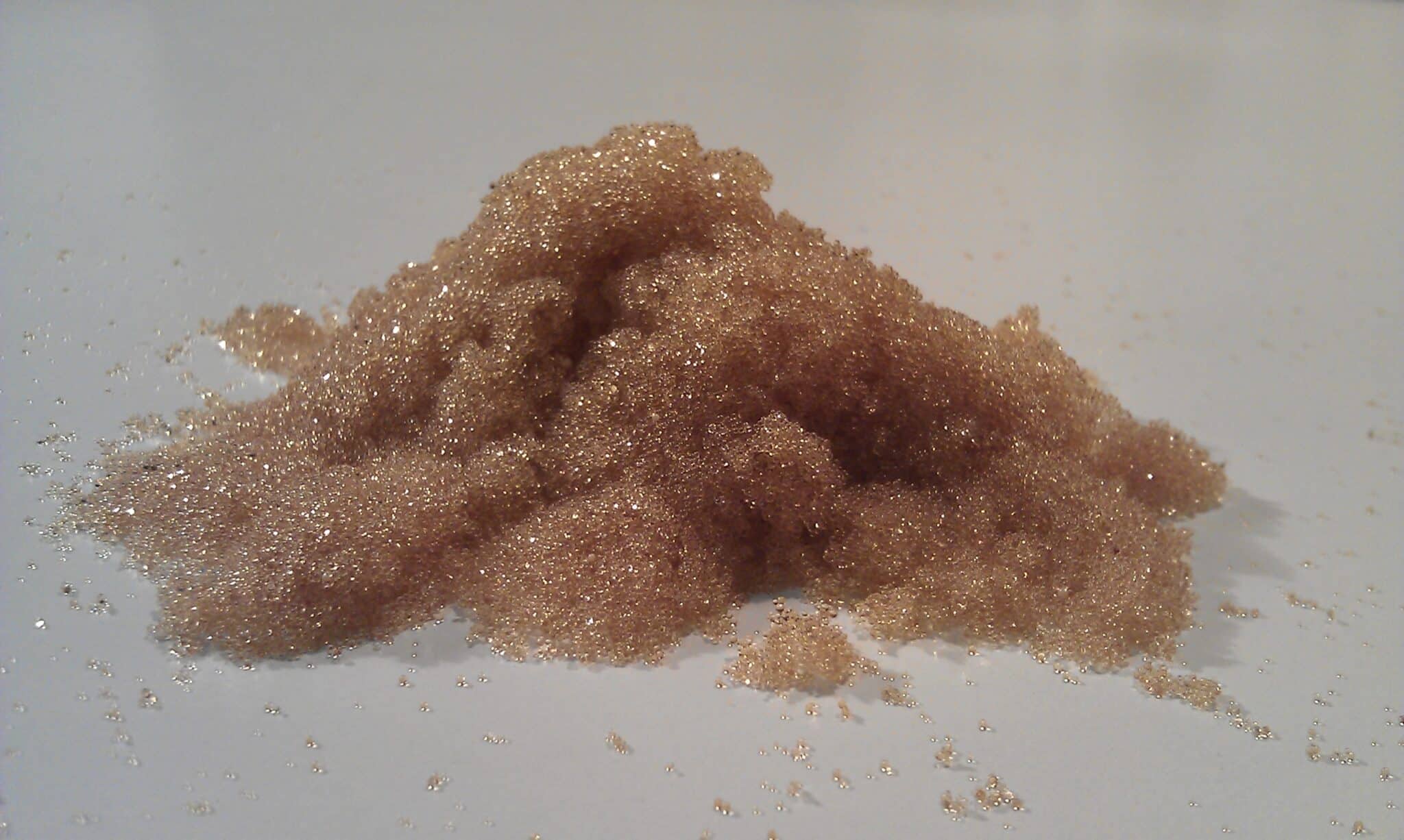 A pile of brown water softener resin beads that efficiently remove hard minerals, delivering softer water, protecting your home’s plumbing, and improving overall water quality.